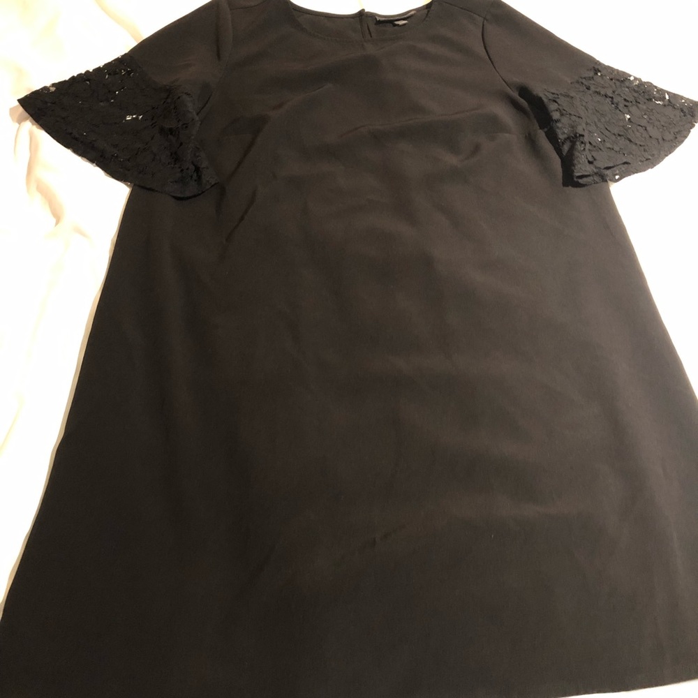 Simple black dress with lace bell sleeves.